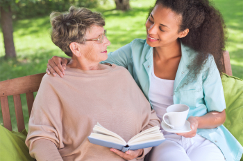 caregiver and senior woman smiling